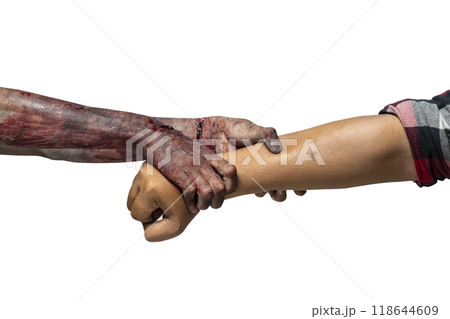 A zombie hand with a bloody wound grabs a human hand. Zombie, devil, evil, satan, or monster hands isolated over a white background 118644609