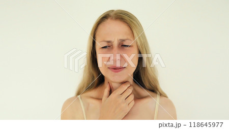 Sick exhausted woman suffering from acute sore in throat flu, touches neck with hand 118645977