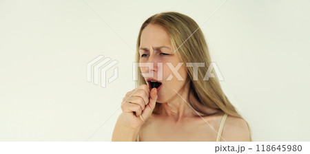 Cold and health, sick mature woman coughing on white background Cold and health, sick mature woman coughing on white background 118645980