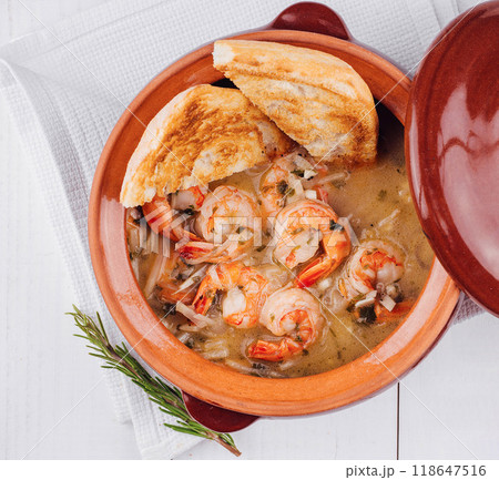 Creamy shrimp stew served in a terracotta bowl with toasted bread and herbs Creamy shrimp stew served in a terracotta bowl with toasted bread and herbs 118647516