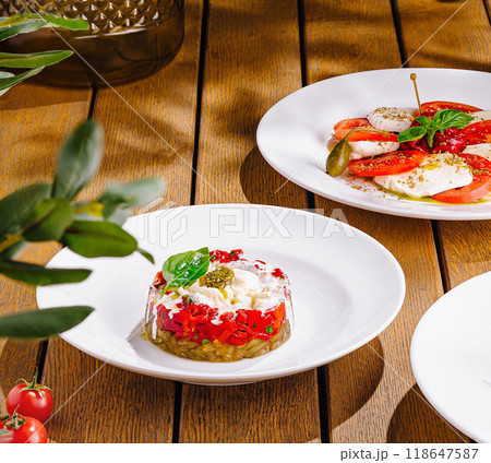 Gourmet tomato and cheese appetizers on elegant table setting Gourmet tomato and cheese appetizers on elegant table setting 118647587