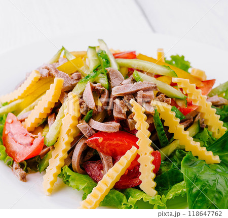 Fresh salad with lettuce, tomatoes, beef tongue and cheese decorated with wavy cheese slices Fresh salad with lettuce, tomatoes, beef tongue and cheese decorated with wavy cheese slices 118647762