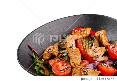Delicious salad with grilled chicken and fresh vegetables on black plate 118647877