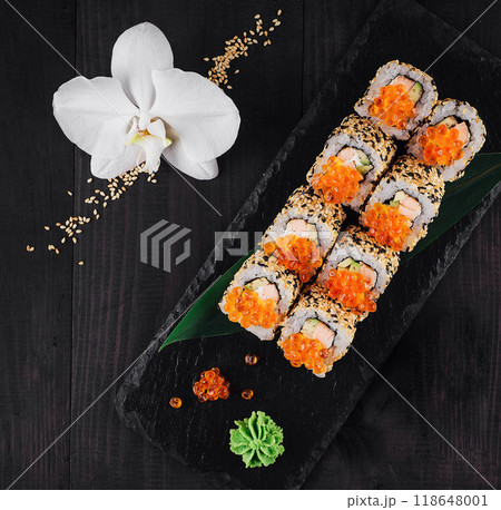 Sushi rolls set served on black stone with ginger and wasabi Sushi rolls set served on black stone with ginger and wasabi 118648001