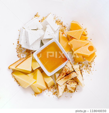 Different types of cheese arranged on plate with honey serving idea 118648030