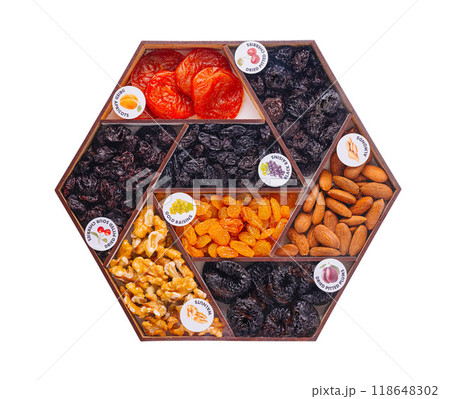 Hexagon shaped wooden box containing dried fruits and nuts 118648302