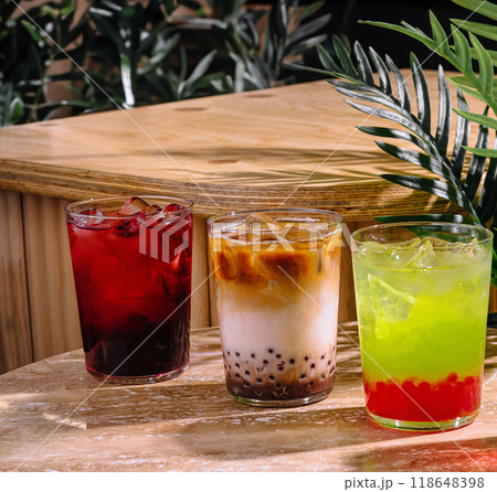 Three refreshing iced beverages with boba resting on table Three refreshing iced beverages with boba resting on table 118648398