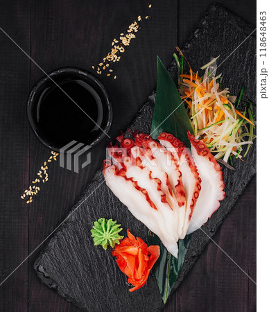 Sliced octopus sashimi with soy sauce and wasabi on slate serving board Sliced octopus sashimi with soy sauce and wasabi on slate serving board 118648463