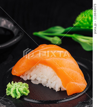 Delicious salmon nigiri sushi with wasabi on black stone plate 118648473
