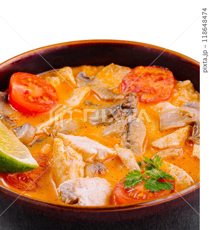 Spicy thai tom yum soup with chicken and mushrooms in brown bowl 118648474