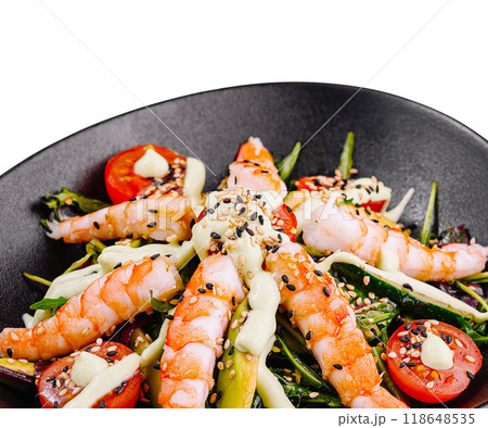 Fresh salad with shrimps, avocado and cherry tomatoes on black plate Fresh salad with shrimps, avocado and cherry tomatoes on black plate 118648535