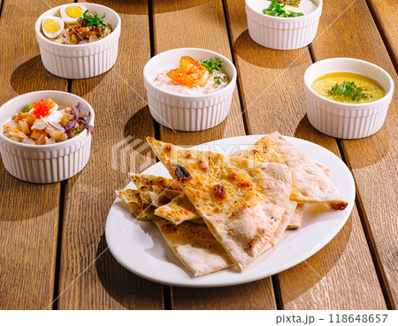 Gourmet mediterranean feast on rustic wooden table 118648657