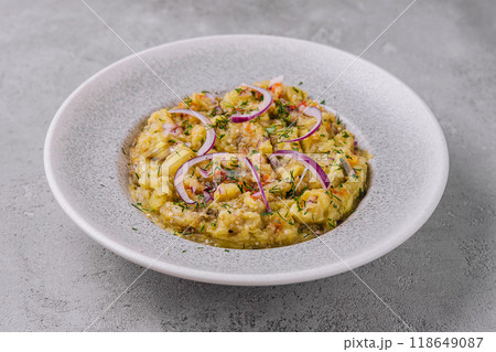 Baba ghanoush with red onions and herbs on a plate 118649087