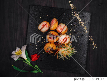 Delicious fried sushi balls being served on black stone plate 118649113