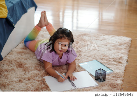 Girl Drawing In Notebook At Home 118649648