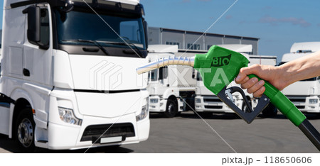 Man with biofuel filling nozzle on a background of truck 118650606