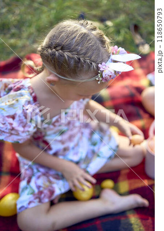 a llittle girl  paint eggs at the easter picnic a llittle girl  paint eggs at the easter picnic 118650793