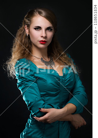 Portrait of a beautiful young woman in a silver vintage necklace Portrait of a beautiful young woman in a silver vintage necklace 118651834