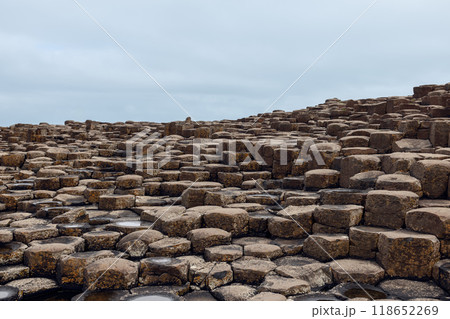 Basalt columns at Giant's Causeway formed by volcanic activity show hexagonal shapes along coastline Basalt columns at Giant's Causeway formed by volcanic activity show hexagonal shapes along coastline 118652269