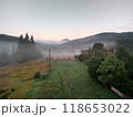 Village in mountains with the view on forest of fir mountains in fog rural horizontal 118653022