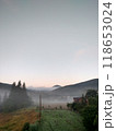 Village in mountains with the view on forest of fir mountains in fog rural vertical 118653024