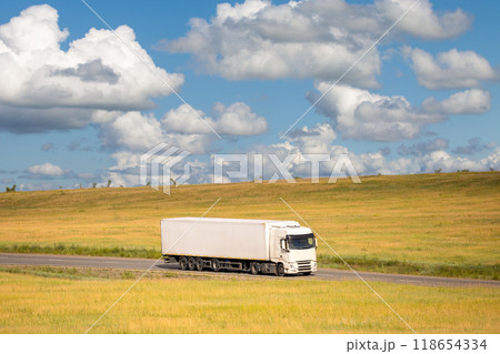 White chinese truck on a road moving in a field 118654334