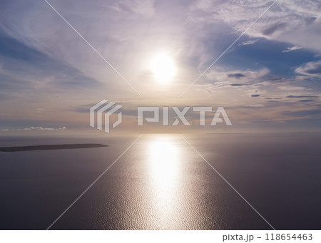 sunset over the ocean aerial view from high altitude, tropical islands in the sea sunset over the ocean aerial view from high altitude, tropical islands in the sea 118654463