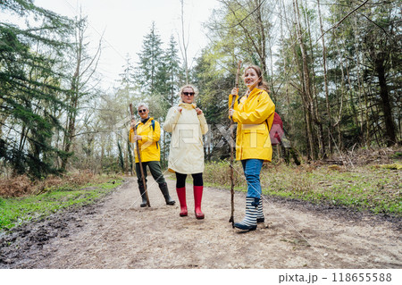 Group of friends walking with backpacks in forest. Trekking travel in adventure lifestyle, nature hiking in vacation holiday with journey. Tourism, hiking, and friendship concept. Outdoor activities 118655588