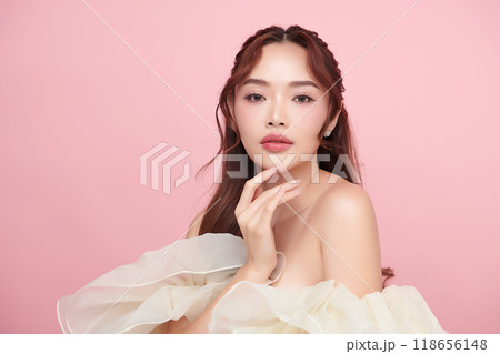 Beautiful young asian woman with clean fresh skin on pink background, Face care, Facial treatment, Cosmetology, beauty and spa, Asian women portrait. Beautiful young asian woman with clean fresh skin on pink background, Face care, Facial treatment, Cosmetology, beauty and spa, Asian women portrait. 118656148