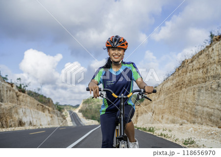 cheerful female biker enjoying riding bicycle 118656970