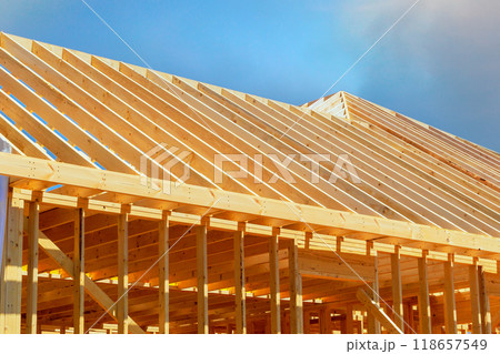Currently under construction, new frame building with rafters, roof beams, construction framework Currently under construction, new frame building with rafters, roof beams, construction framework 118657549