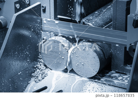 The band saw cutting machine cutting the metal shaft parts with liquid coolant method. The band saw cutting machine cutting the metal shaft parts with liquid coolant method. 118657835