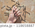 selective focus at the female hand, holding screws, concept of tight and strong 118658887