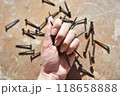 selective focus at the female hand, holding screws 118658888