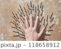 the hand surronded ith screws on the old wooden table 118658912