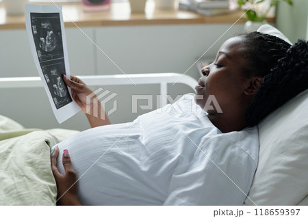 Expecting Mother Viewing Ultrasound Image in Hospital Bed 118659397