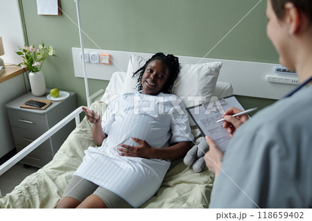 Conversing Nurse and Patient in Healthcare Setting 118659402