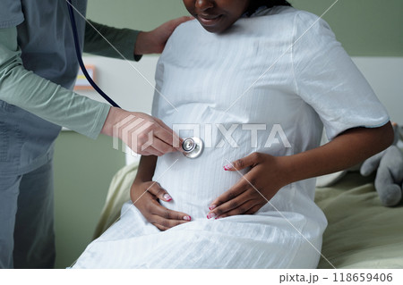 Pregnant Woman Receiving Prenatal Check-Up by Doctor 118659406