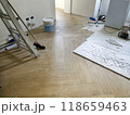 Room under renovation with wooden flooring and construction tools 118659463