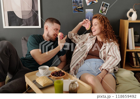 Dates having breakfast on double bed Dates having breakfast on double bed 118659492