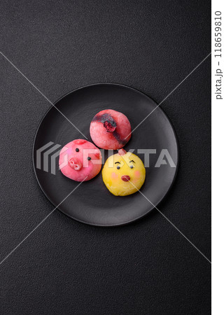 Delicious cold Japanese mochi dessert with colorful rice dough shell and fruit filling Delicious cold Japanese mochi dessert with colorful rice dough shell and fruit filling 118659810