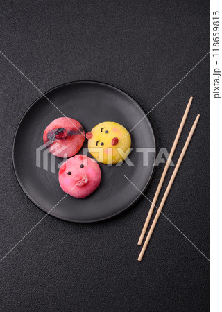 Delicious cold Japanese mochi dessert with colorful rice dough shell and fruit filling Delicious cold Japanese mochi dessert with colorful rice dough shell and fruit filling 118659813