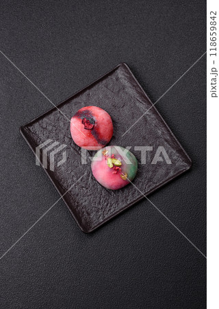 Delicious cold Japanese mochi dessert with colorful rice dough shell and fruit filling 118659842