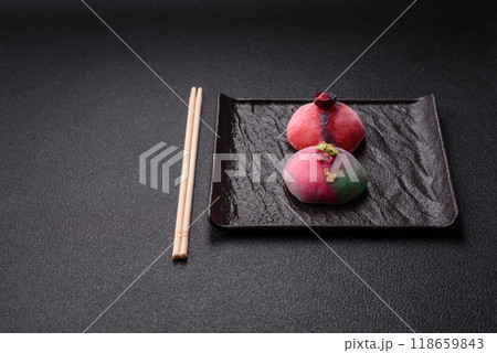 Delicious cold Japanese mochi dessert with colorful rice dough shell and fruit filling 118659843