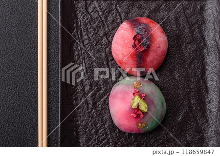 Delicious cold Japanese mochi dessert with colorful rice dough shell and fruit filling Delicious cold Japanese mochi dessert with colorful rice dough shell and fruit filling 118659847