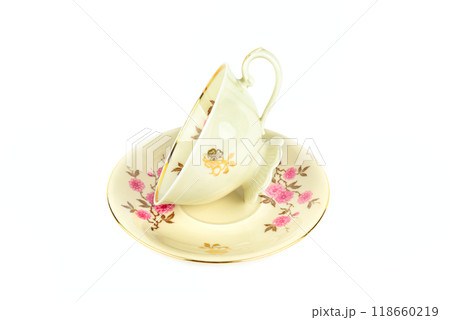 Vintage porcelain cup and saucer isolated on white. Vintage porcelain cup and saucer isolated on white. 118660219