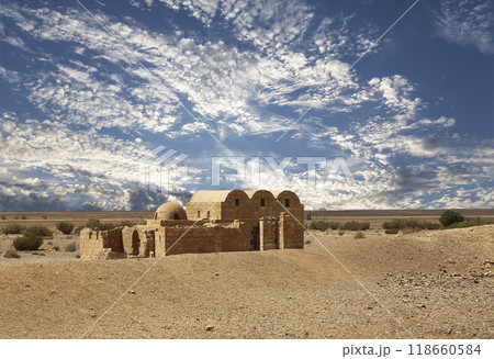 Quseir (Qasr) Amra desert castle (against the sky with clouds) near Amman, Jordan. World heritage with famous fresco's. Built in 8th century, of early Islamic art and architecture Quseir (Qasr) Amra desert castle (against the sky with clouds) near Amman, Jordan. World heritage with famous fresco's. Built in 8th century, of early Islamic art and architecture 118660584
