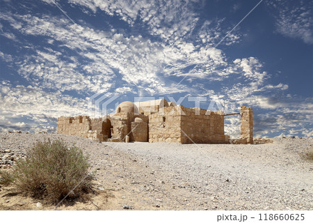 Quseir (Qasr) Amra desert castle (against the sky with clouds) near Amman, Jordan. World heritage with famous fresco's. Built in 8th century, of early Islamic art and architecture Quseir (Qasr) Amra desert castle (against the sky with clouds) near Amman, Jordan. World heritage with famous fresco's. Built in 8th century, of early Islamic art and architecture 118660625