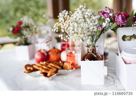 a beautifully set table outdoors, featuring small vases of delic 118660730