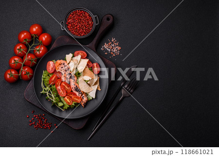 Delicious fresh caesar salad with salmon, lettuce, tomatoes and egg Delicious fresh caesar salad with salmon, lettuce, tomatoes and egg 118661021